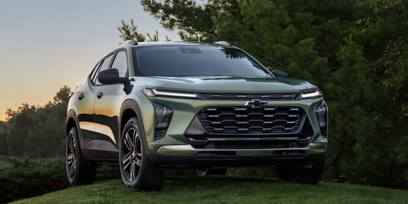 Green Chevrolet SUV parked outdoors near trees.